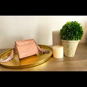 Mini tasseled crossbody bag. Can be worn as clutch